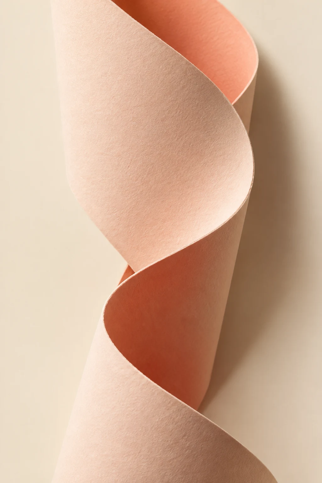 Tactile peach paper curled into flowing folds